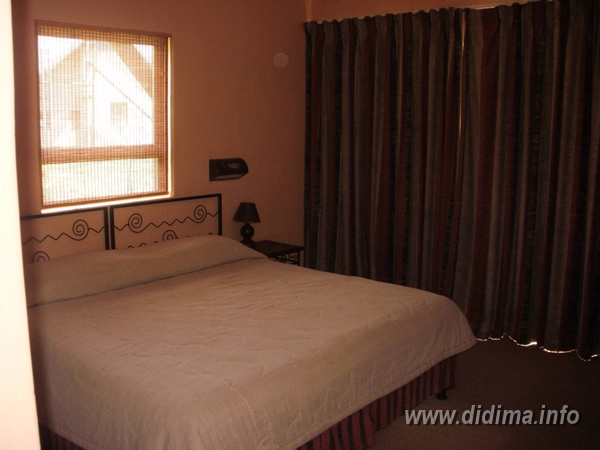 Double bedroom inside a four-sleeper two-bedroom chalet at Didima Camp