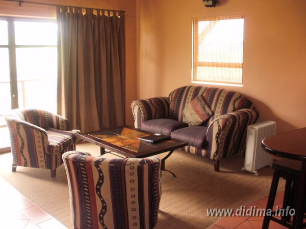 Comfortable lounge inside a six-sleeper self-catering chalet at Didima Camp