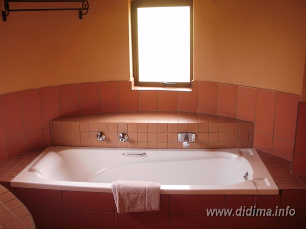 Private bathroom with large bath inside a six-sleeper Didima Camp chalet