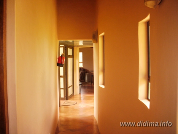 Interior passage connecting the bedrooms in a six-sleeper chalet at Didima Camp