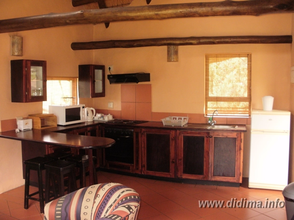 Equipped kitchen and breakfast counter in a six-sleeper self-catering chalet at Didima Camp