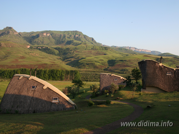 Panoramic view of Didima Camp chalets beneath the rugged Central Drakensberg mountains