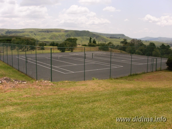 Outdoor tennis courts surrounded by mountain scenery at Didima Camp