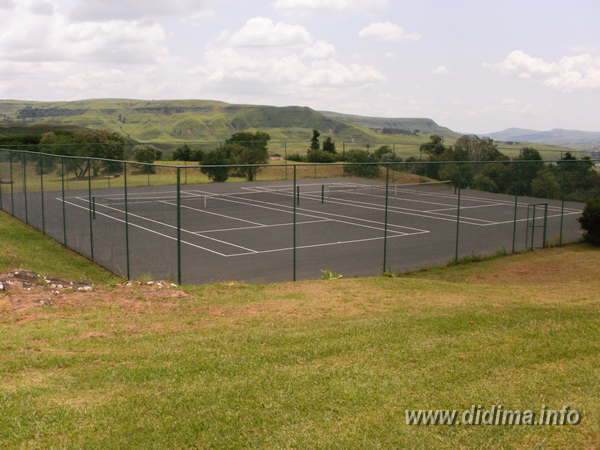 Outdoor tennis courts surrounded by mountain scenery at Didima Camp